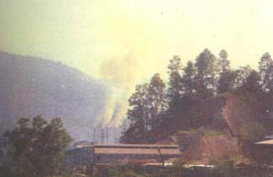Site of the blue sky is obscured by smoke emitted industrial units in Byrnihat 